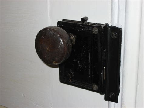 old house with little metal knobs on floor|metal anchors on old homes.